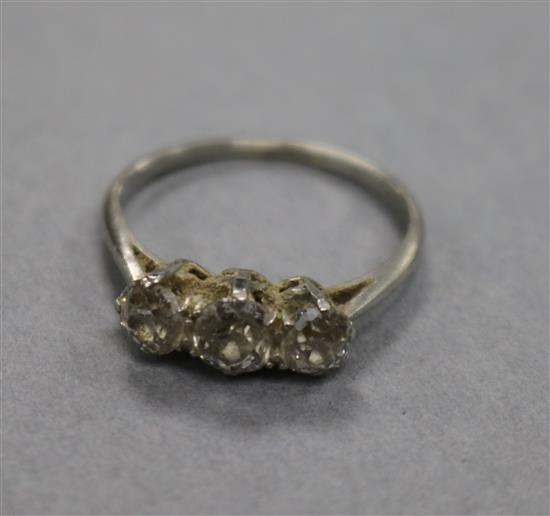 A white metal and three stone diamond ring, size O.
